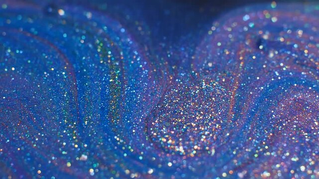 Abstract macro shot showcasing fluid swirls of blue and purple tones, sprinkled with glitter