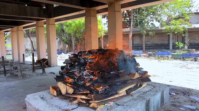 Hindu Cremation Ritual with Burning Pyre at Traditional Cemetery