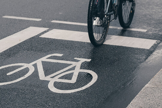 Asphalt icon detail in Frankfurt Germany shows bicycle commute transport on urban city street where cycleway infrastructure mobility signals sustainable traffic planning