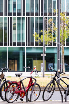 Bicycle parking outside offices in Frankfurt Germany shows bicycle commute transport within urban city street life where cycleway infrastructure mobility supports sustainable work culture