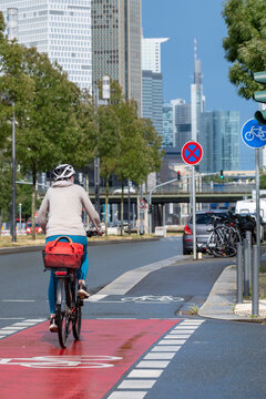 Downtown approach in Frankfurt Germany shows bicycle commute transport on urban city street where cycleway infrastructure mobility reflects sustainable metropolitan commuting