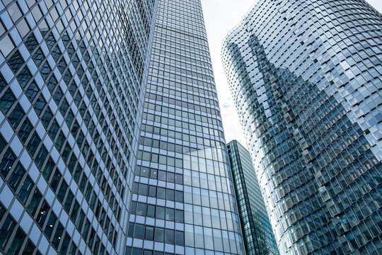 Modern glass facade with reflection and pattern on towers in La Defense paris skyline capturing urban architecture in finance business setting