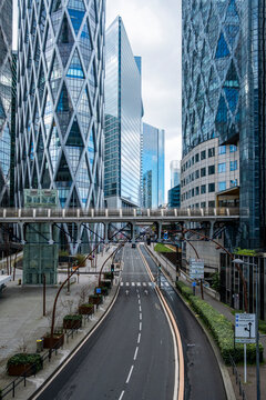 Empty boulevard in La Defense paris leads toward modern towers and skyline highlighting urban architecture for finance and business growth