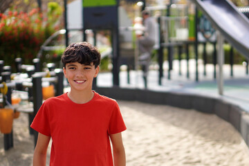 Fototapeta premium Healthy leisure and free time with the family. Preteen boy in the park with his father in the background.
