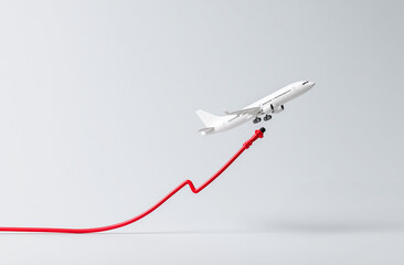 Fototapeta premium Airplane silhouette with rising red graph line, aviation industry recovery and airfare