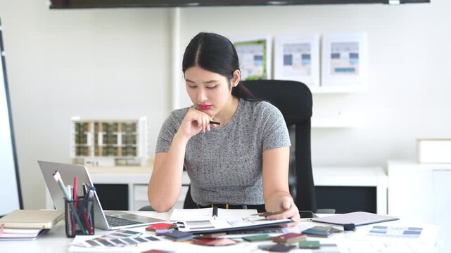 Architect or interior designers are finalizing the design of interiors by discussing selecting materials and colors to design rooms to present to clients.