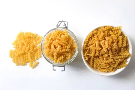 fusilli pasta in various containers isolated on white background