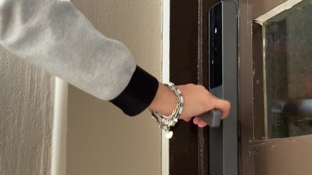 Woman hand using smart lock fingerprint scanner
