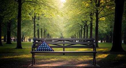 Folded american flag resting on park bench during memorial day tribute in peaceful garden.