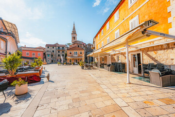 Fototapeta premium Jelsa town on Hvar island, with traditional Dalmatian stone architecture and boats moored in the harbor, Croatia.