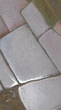 Stunning vertical video close-up of glistening salt crystals forming geometric shapes at Salinas de Manaure, La Guajira. Natural sunlight highlights texture. Ideal for mobile, social reels.