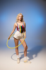 Summer fun with a beautiful woman in vibrant attire and a hula hoop © LIGHTFIELD STUDIOS
