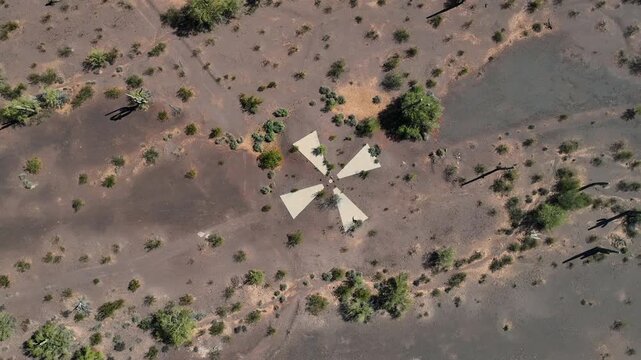 Aerial view of a striking white star-shaped ground marking boldly contrasting with the rugged reddish-brown desert terrain, Casa Grande, Arizona, United States.