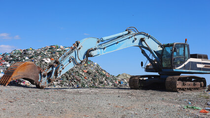 Blue Excavator Working At Large Landfill Site © M.IVA