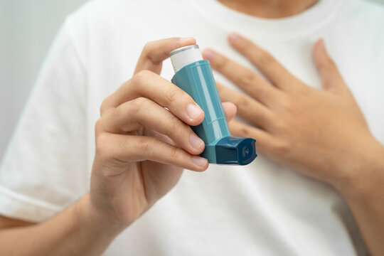 Asthma and chronic obstructive pulmonary disease COPD, Asian teenage using metered dose inhaler MDI.