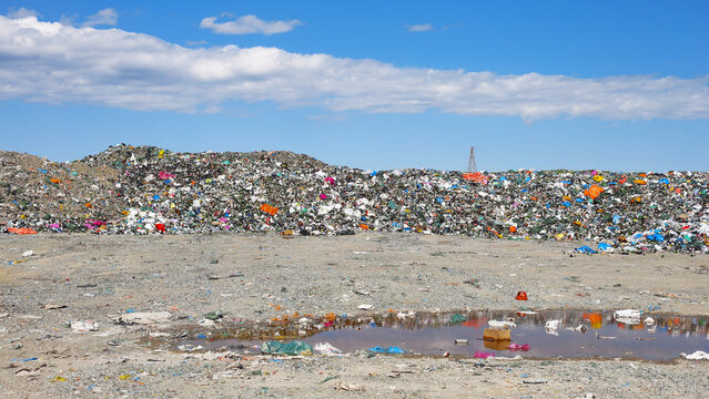 Vast landfill with scattered plastic waste