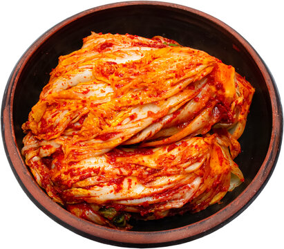 Napa cabbage kimchi in traditional brown earthenware bowl isolated on transparent background, PNG