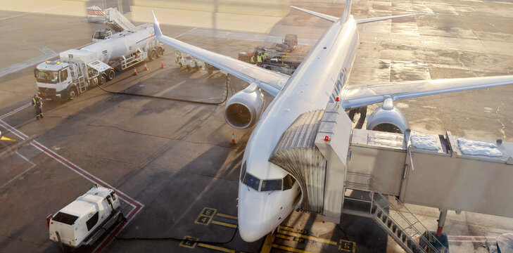 15 January 2026, Belgrade, Serbia: Commercial airplane connected to jet bridge and fuel truck on tarmac, preparing for departure or arrival
