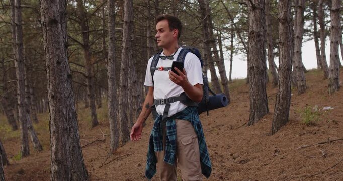 Hiker man with smartphone lost signal in forest during hiking. In backpack, tourist checks map and navigation, facing no service outdoors, travel routes. Concept lost mobile navigation problem.