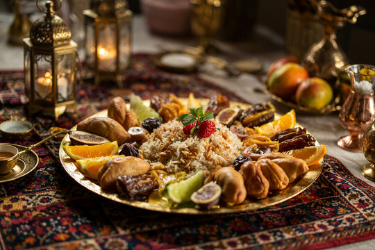 Traditional ramadan iftar platter with rice, dates, and fresh fruits