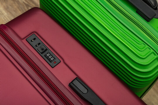 Closing a combination lock on a suitcase at the airport, checking the lock on a suitcase, attempting to break into a suitcase, combination lock on a travel bag,