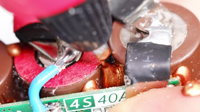 An expert conducts repairs on electronic circuits