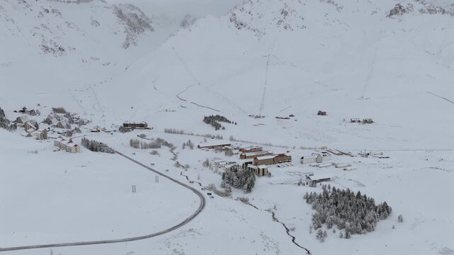 Aerial side view of Las Lenas ski resort in Andes mountains during winter, snowy landscape and alpine tourism destination.