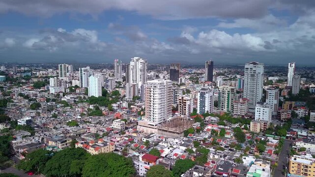 Modern high-rise apartment buildings and urban development in Alma Rosa district of Santo Domingo Este, Dominican Republic. Aerial drone orbiting