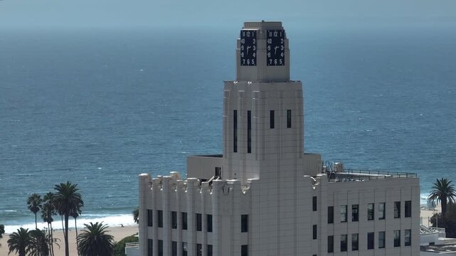 Telephoto drone shot of the historic clock tower building and Santa Monica Beach
