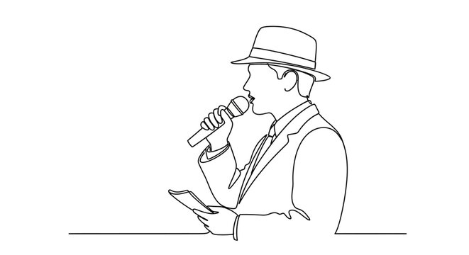 Man in hat holding microphone reading.