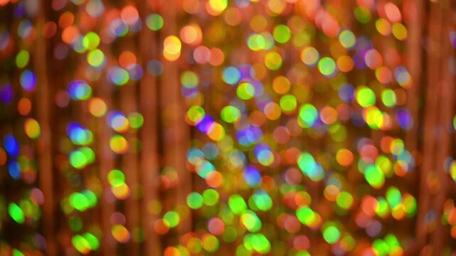 Rainbow bokeh lights shimmer. colorful dots shift smoothly in continuous motion. Dynamic circles produce vivid festive background. Abstract colorful pattern emerges from multicolor bokeh backdrop.