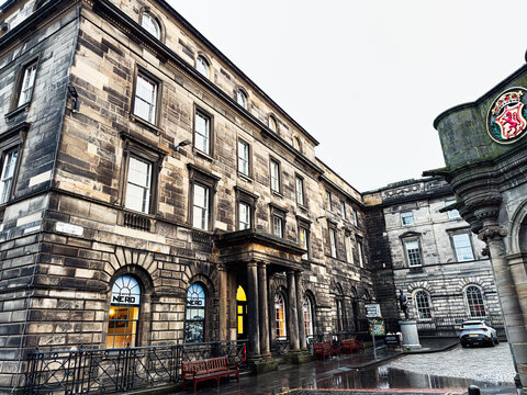 Historic stone building and cafe on a rainy Parliament Square street in Edinburgh, Scotland, UK, Georgian architecture, urban heritage and city life by a cobbled square