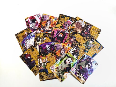Naruto cards isolated on white background. Indonesian youths playing these collectible cards for have fun