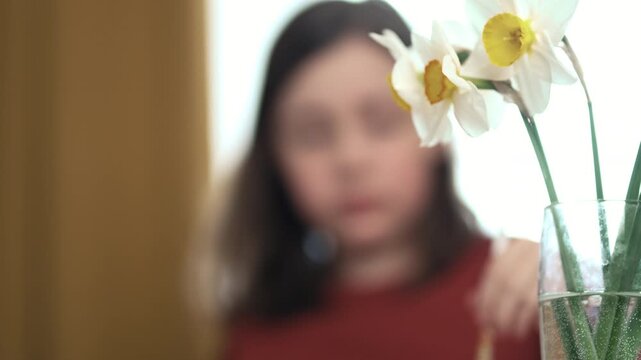 Little girl painting Easter eggs at home, 4K 10-bit cinematic footage of child decorating colorful eggs with watercolor brush for spring holiday, authentic lifestyle.