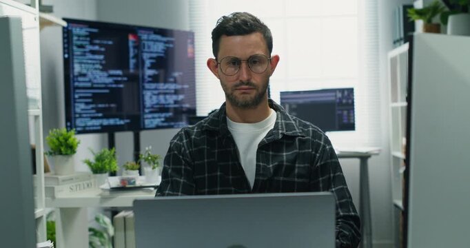 Caucasian developer analyzes data and writes secure code, mapping network protocols, AI tools and application logic in a business office, focused on innovation and system integrity.