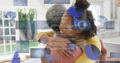 Fototapeta premium Hugging two women in bright kitchen, with yellow top, pink top, AR overlays, glass doors