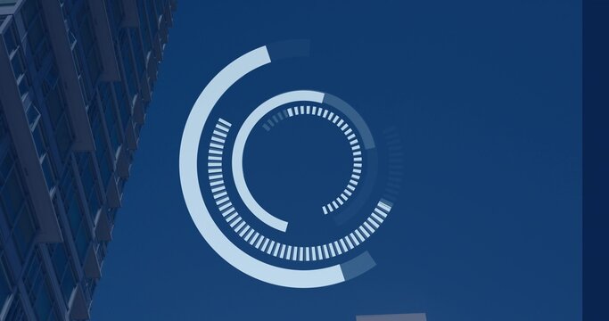Displaying concentric HUD-style graphic hovering over clear blue sky, with high-rise facade