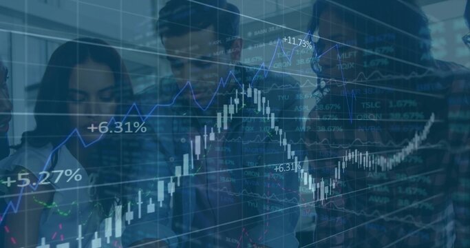Viewing team of five wearing business clothing studying market data in boardroom with candlesticks