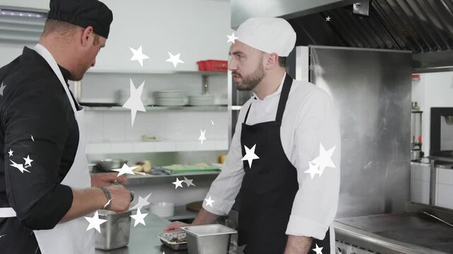Chef scooping, plating for service in kitchen, sous chef watching star overlay drifting in front