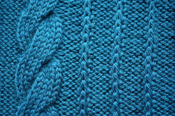 Fototapeta premium macro texture of teal knitted fabric with detailed pattern. Close-up of soft textile surface showing rich blue-green tones and woven structure. Modern and stylish background perfect for technology, bu