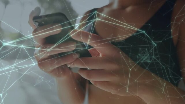 Woman tapping smartphone by window starting sync while network overlay covering phone and hands