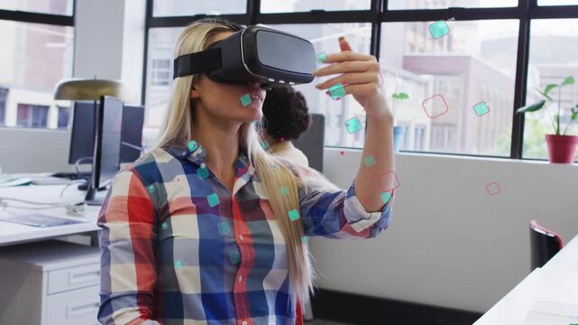 Seated woman wearing VR headset making pinching sweeps moving turquoise and red squares for UI test