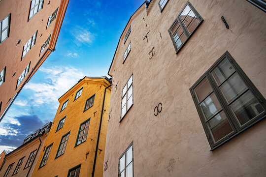 Colorful historical buildings under a blue sky in the Old Town of Stockholm, Sweden.