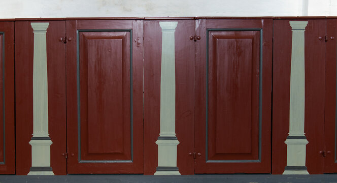 old wooden door with red wall