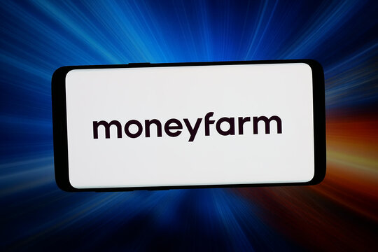 Stuttgart, Germany - 04-13-2026: In this photo illustration, the logo of company MFM Investment Ltd. (MoneyFarm) is displayed on a smartphone in front of abstract background on computer screen.