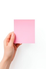 Obraz premium Pink pastel Sticky note holding paper hand.