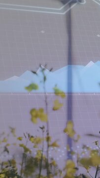 Vertical video: Camera rising revealing turbine; yellow blooms swaying, overlay showing energy data