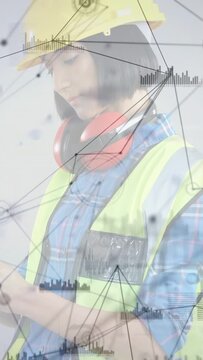 Vertical video: Site tech checking tablet then placing helmet safely while HUD responding to tablet