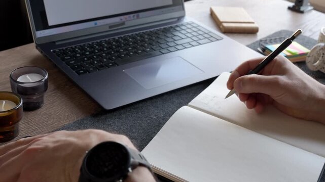 Man checking smartphone with unknown caller screen at desk with laptop and notebook. Incoming call disrupting person at workplace. Concept of mobile communication, scam call and distraction