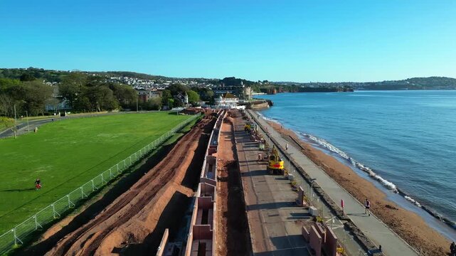 Paignton, Devon, England: DRONE VIEWS: A sea defence wall under construction on Paignton Green. The project will be completed in 2027 to protect seafront properties from global rising sea levels.